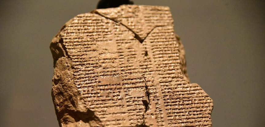 A stone with writing on it

Description automatically generated